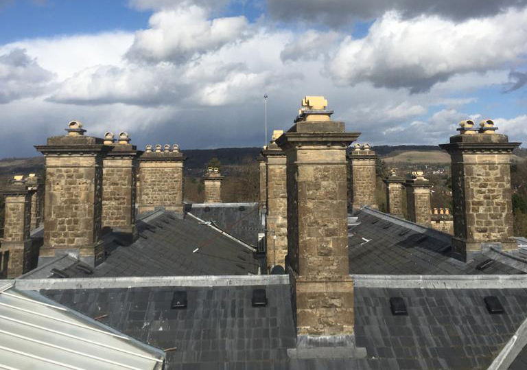 Overshot of houses with chimneys on a cloudy day